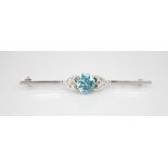 An Art Deco zircon and diamond platinum bar brooch, the central round mixed cut zircon measuring 8.