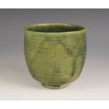 An Anamese pottery vessel, possibly 15th century, the cylindrical vase celadon glazed to the