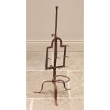 An early 19th century iron lark spit, the break-arch frame upon a tripod stand extending to spade