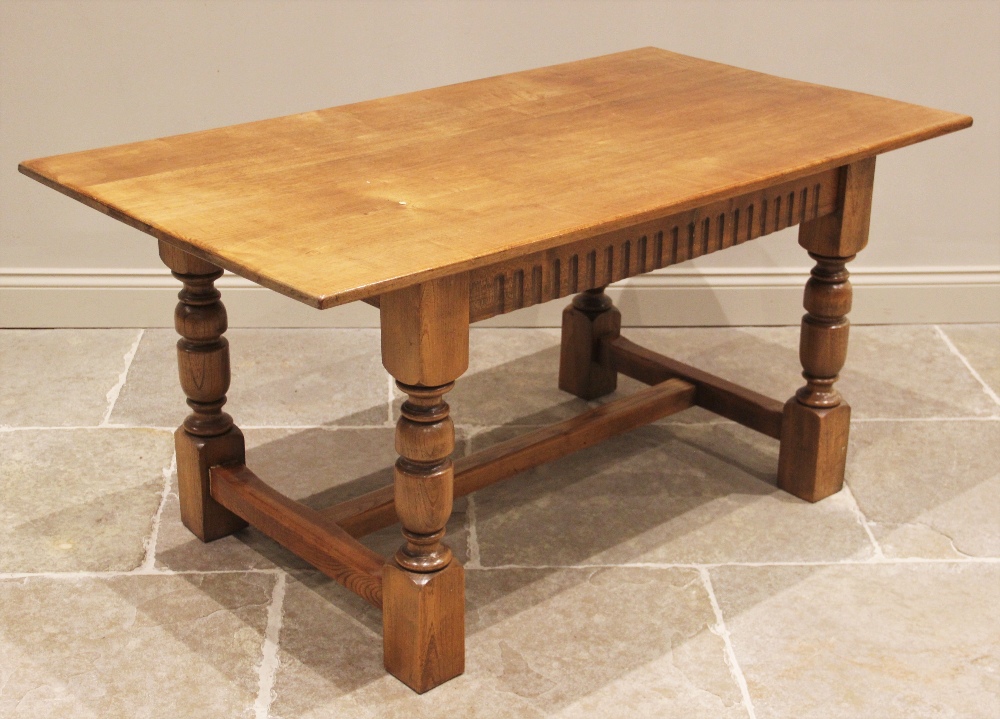 A 17th century style honey oak refectory table, 20th century, the rectangular top above a nulled - Image 3 of 3