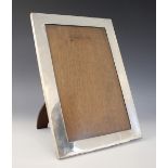 A George V silver mounted photograph frame, Johnson, Walker & Tolhurst, London 1911, of plain