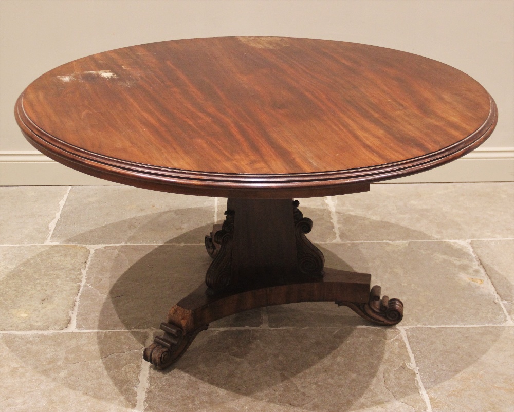 A mid 19th century mahogany centre table, the circular moulded top upon a triform pedestal applied