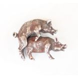 An early 20th century Russian silver model of two mounted pigs, modelled realistically with fur