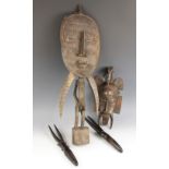 A Senufo Kpelie mask, Ivory coast, 41cm high, with an African tribal carving of a fertility