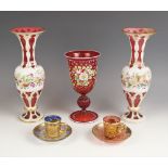 A pair of Bohemian cased ruby and white overlay glass vases, circa 1880, each decorated with