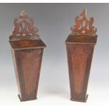 A near pair of George III oak candle boxes, each of typical tapering form below a pierced fret