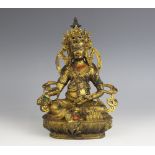A South East Asian gilt model of Jambhala, modelled seated with the right hand grasping a bijapuraka