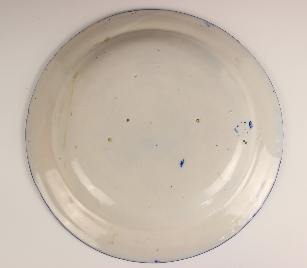 A continental faience tin glazed blue and white charger, late 19th century, painted in underglaze - Image 2 of 2