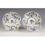 A pair of Worcester porcelain part reeded teacups and saucers, circa 1770-1790, painted in