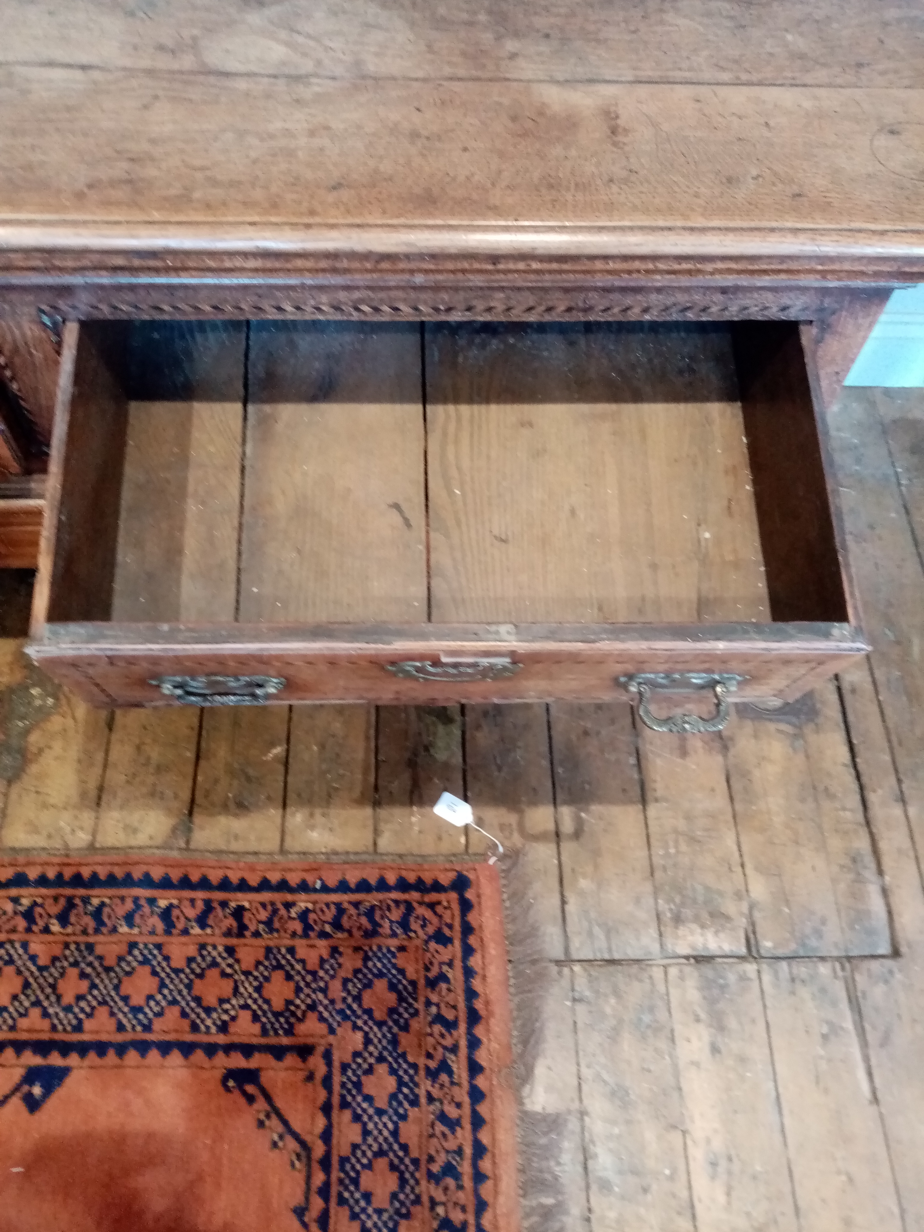 A George III oak dresser base, the rectangular moulded three plank top above three lip moulded - Image 10 of 15