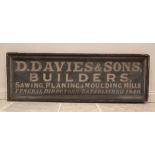 A painted wooden builders advertising sign, mid 19th century, the white drop shadow lettering on a