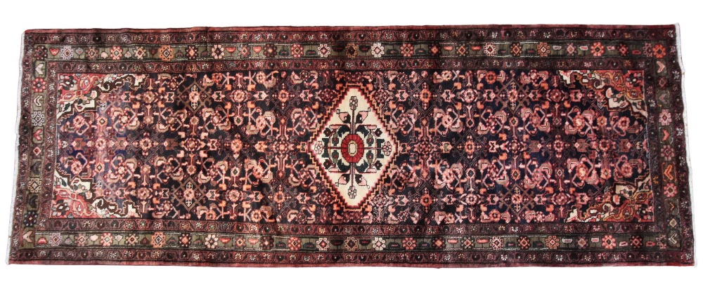 A Persian Hamadan runner, in deep brown and red colourways, the central foliate lozenge shaped