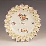 A Derby porcelain "Spectacle" plate, circa 1758-1760, the well decorated with polychrome enamel