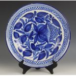 A continental faience tin glazed blue and white charger, late 19th century, painted in underglaze