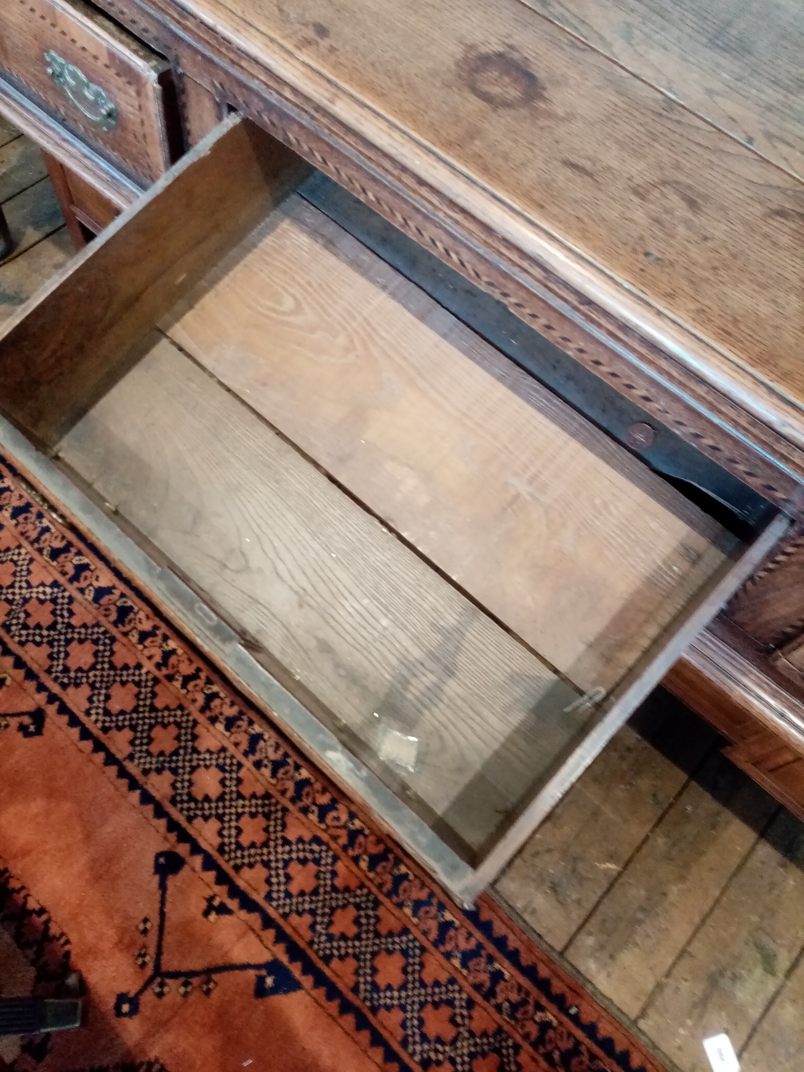 A George III oak dresser base, the rectangular moulded three plank top above three lip moulded - Image 11 of 15