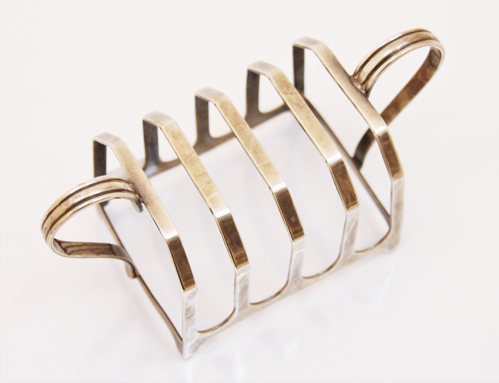 A George VI silver two handled toast rack, G M and S, Birmingham 1939, the four division rack of