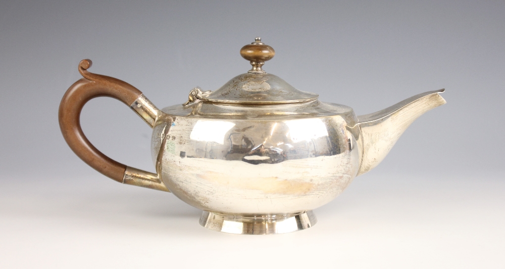 A George V silver teapot, Hukin and Heath Ltd, Birmingham 1924, of compressed globular form on