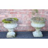 A pair of reconstituted stone garden planters, of lobed urn form, upon integral plinth bases, 41cm
