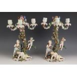 A pair of German porcelain figural candelabra's, early 20th century, each naturalistic tree-form