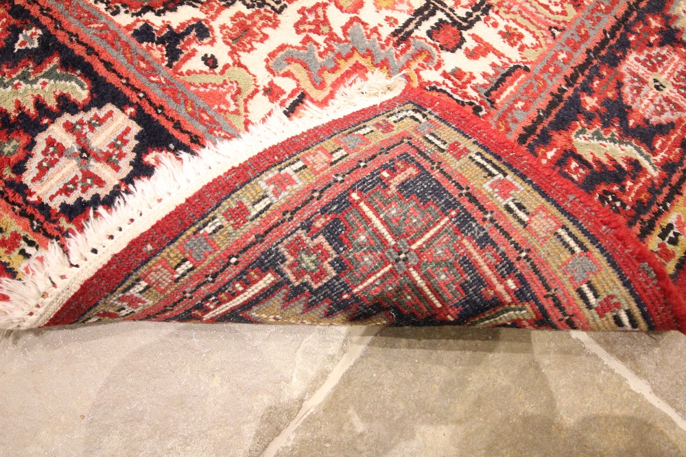 A vintage terracotta ground Persian Heriz rug, north Iran, in red, blue, green and ivory colourways, - Image 2 of 2