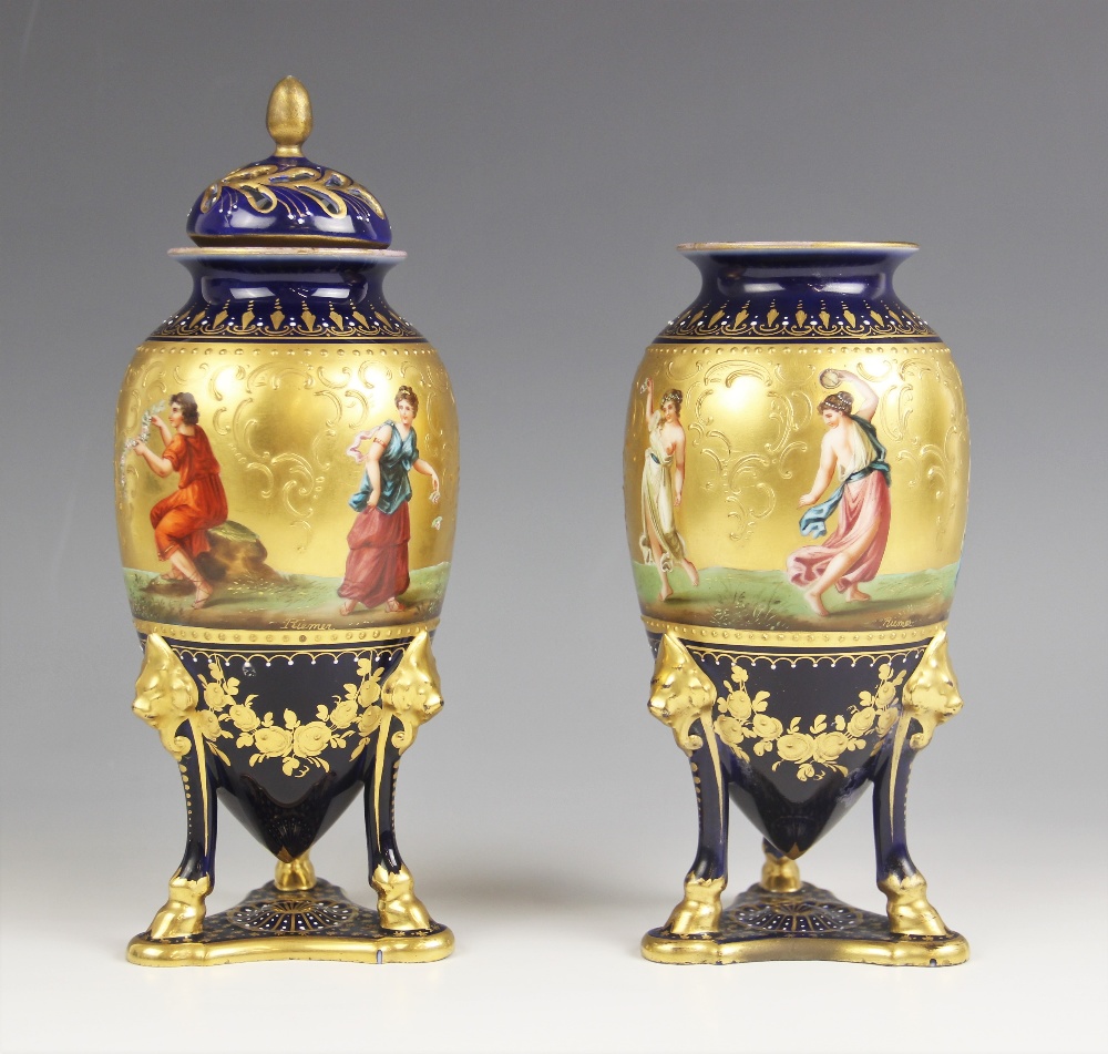 A pair of Vienna porcelain urn vases and a cover, early 20th century, each ovoid vase finely