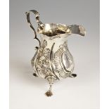 A Victorian silver cream jug, 'W.H', London 1844, of baluster form with scroll handle and ogee