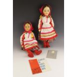 Two vintage hard plastic Russian dolls, mid 20th century, both dressed in traditional national