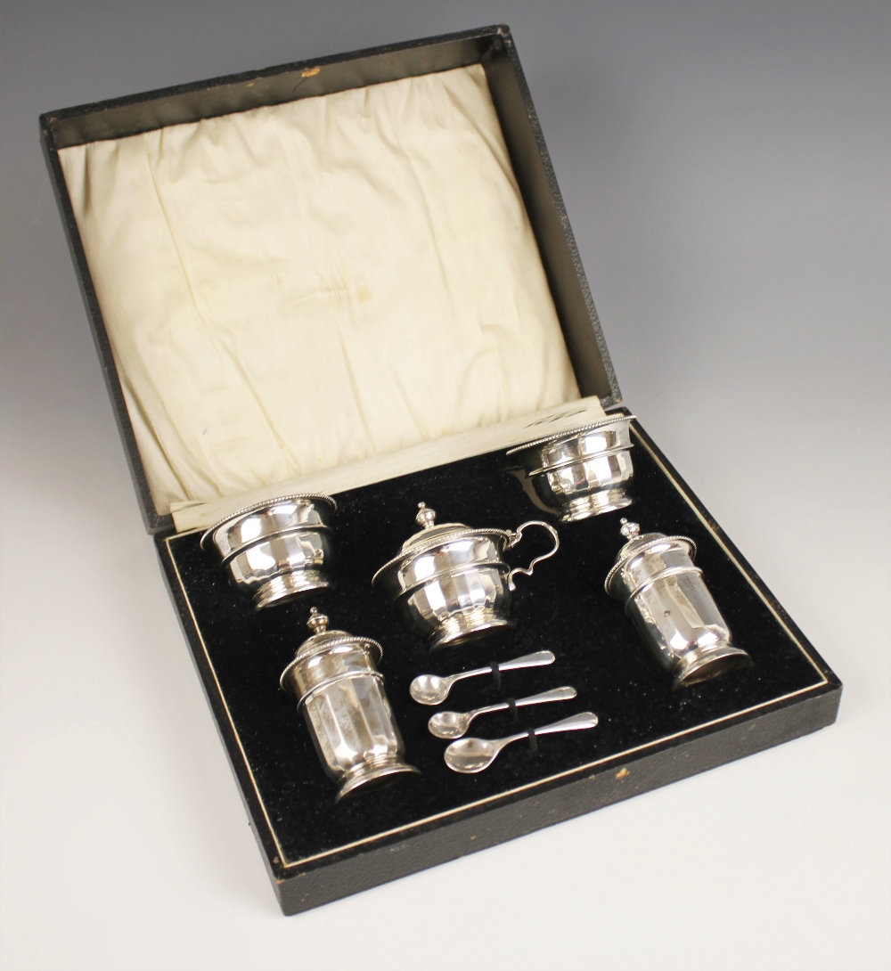 A George V silver condiment set, Adie Brothers, Birmingham 1932, comprising two open salts, two