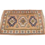 A Turkish wool rug made by Turgut Koy carpet weavers, in green, blue and pink colourways, the