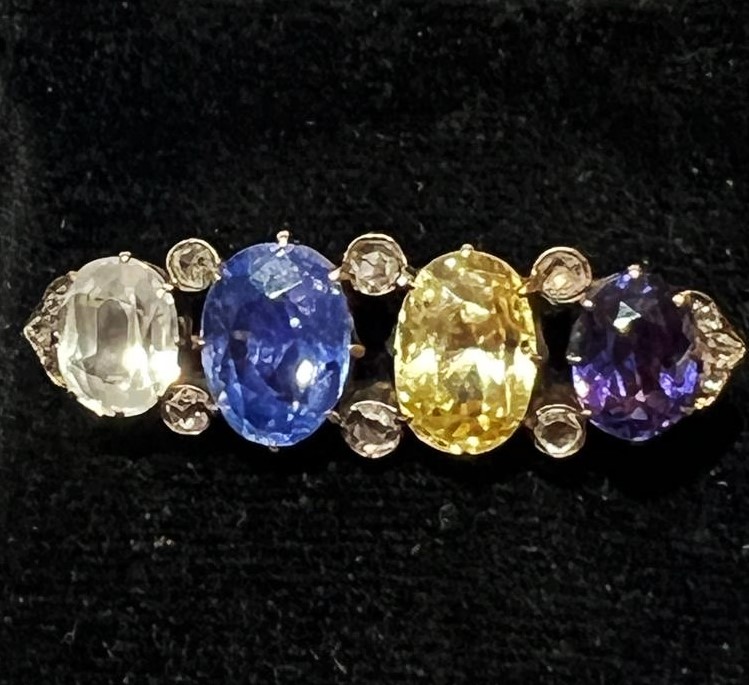 An late 19th/early 20th century sapphire and diamond brooch, comprising a colourless sapphire (7.