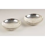 A near pair of George V silver bonbon dishes, 'C.E' London 1932 and 1935, the circular planished