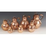 An associated set of graduated copper Guernsey cream jugs by Martin's, each of typical form with