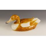 A Portuguese pottery duck egg holder, modelled as a yellow and white duck with removable back,