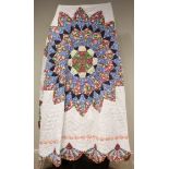 An early 20th century quilt, with central radiating circular medallion in pink, blue and green,