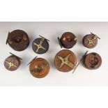 A collection of eight walnut and brass mounted centrepin fishing reels, early 20th century and