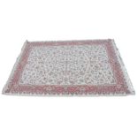 A large fine woven ivory ground Iranian carpet, the central field with an all over floral design,