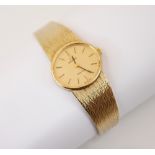 A 9ct yellow gold ladies Omega Geneve wristwatch, the oval textured champagne coloured dial with