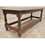 A 17th century style oak refectory table, 19th century, the cleated four plank top upon baluster and