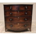 An early 19th century mahogany bowfront chest of drawers, with an arrangement of two short over