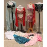 A collection of belly dancing outfits, 20th century, to include a 'Simone Bomentre Atelier' red