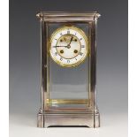 A late 19th century chromed four glass mantel clock, the four bevelled glass panels enclosing the