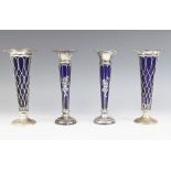 A pair of Edwardian silver posy vases, Thomas Bradbury and Sons Ltd, Birmingham 1906, the flared