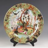 A boxed Wedgewood Fairyland Lustre charger in the "Ghostly Wood" pattern designed by Daisy Makeig-