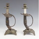 A pair of WWI German sword hilt candlesticks, the hilt guards cast in open relief with an eagle