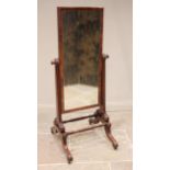 A Regency mahogany cheval mirror, the rectangular mirrored plate within a plain moulded frame,