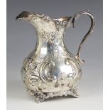 An Edwardian silver milk jug, Johnson, Durban and Co Ltd, Birmingham 1904, the cast scrolling rim