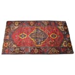 A multi coloured ground Pakistan Baluchi rug, in red, blue, brown and yellow colourways, the