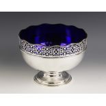 A silver plated fruit bowl, of circular form with pierced scrolling border and waved beaded rim,