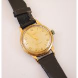 A yellow metal cased JW Benson shock absorber gentleman's wristwatch, the circular champagne