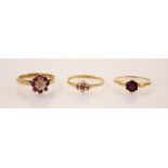 A ruby and diamond 9ct gold cluster ring, the central raised illusion set diamond chip within a